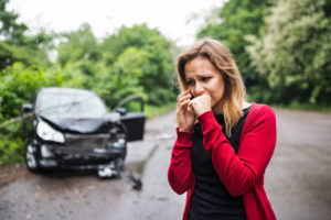 distressed woman calls for help after a car crash