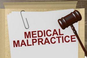 medical malpractice written on paper and a gavel