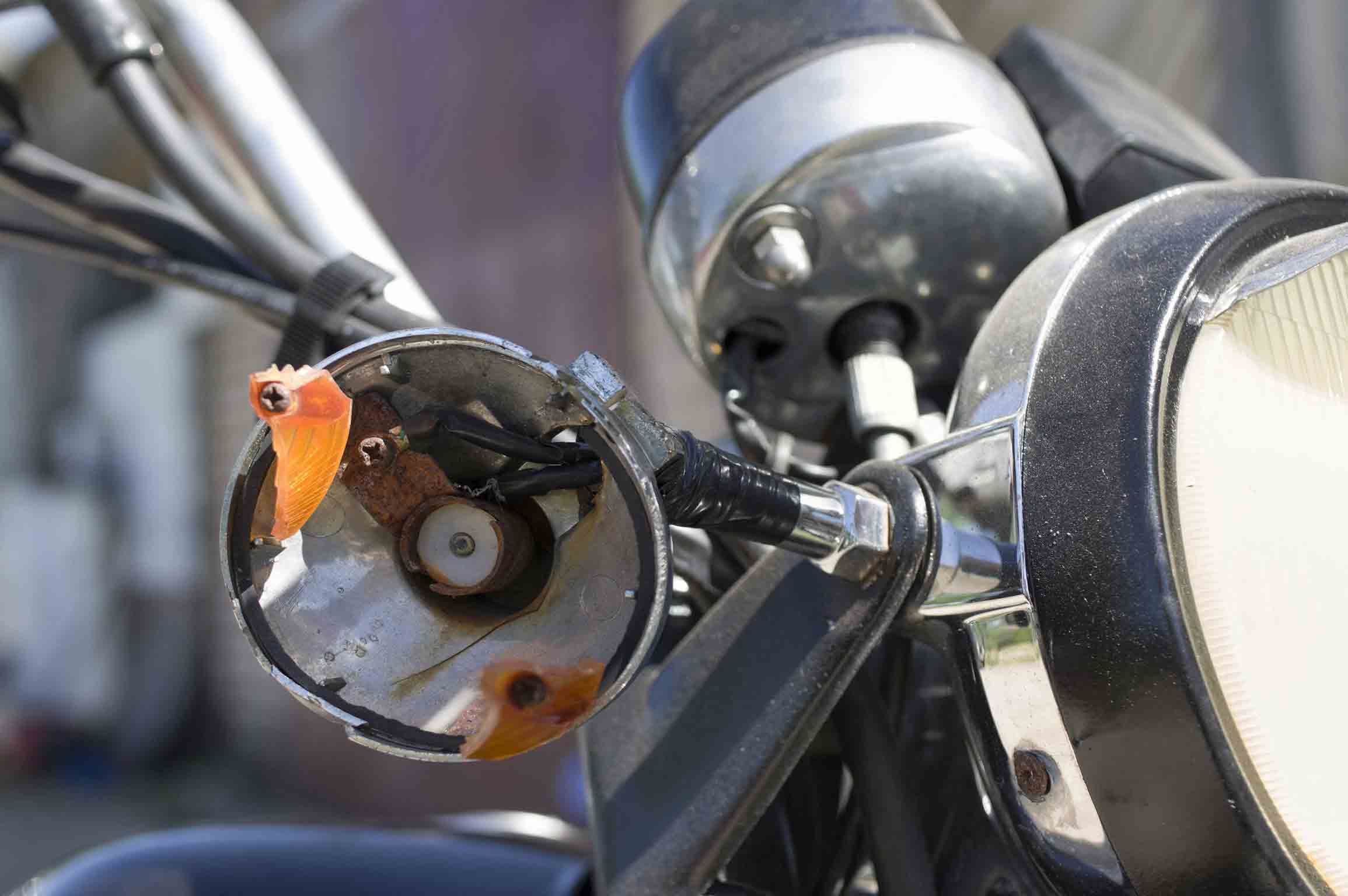 closeup of broken motorcycle light after accident