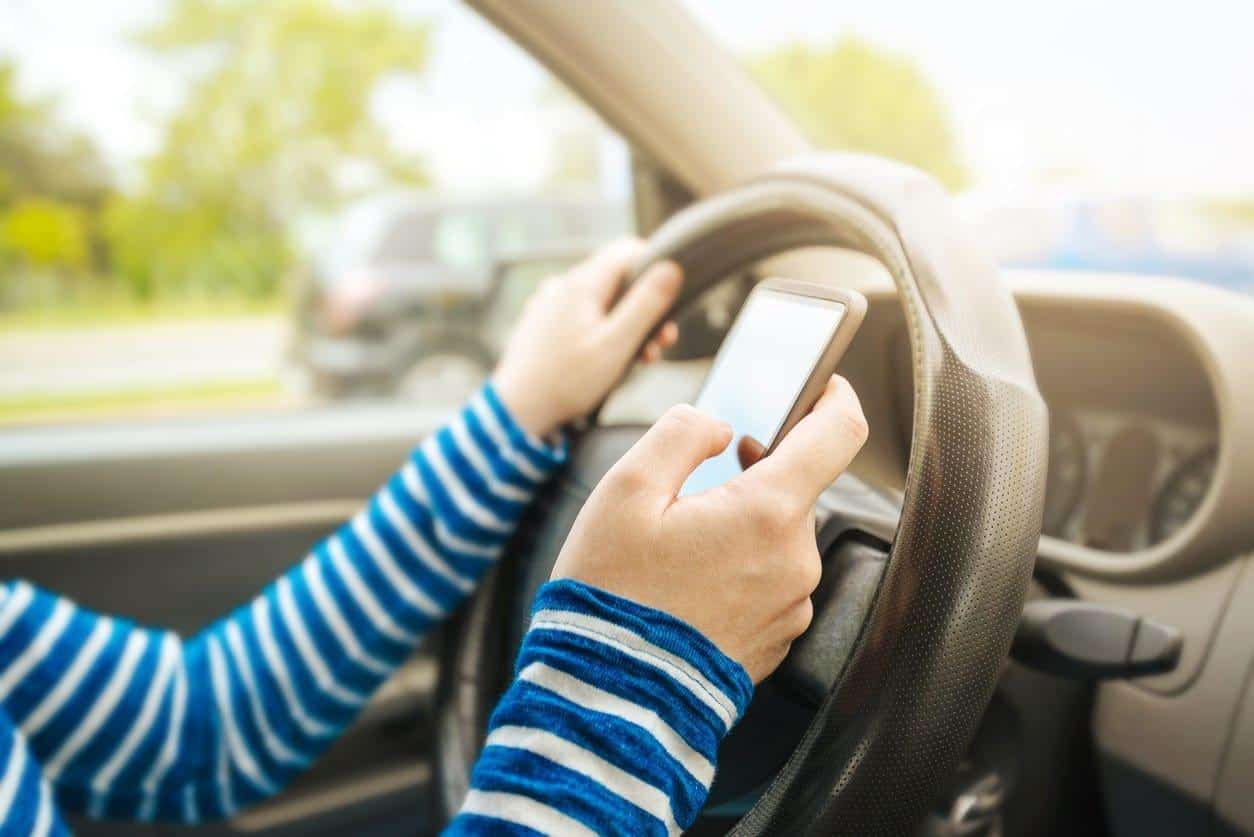 a woman texting while driving