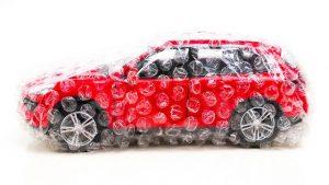 red SUV covered in bubble wrap, an insurance metaphor
