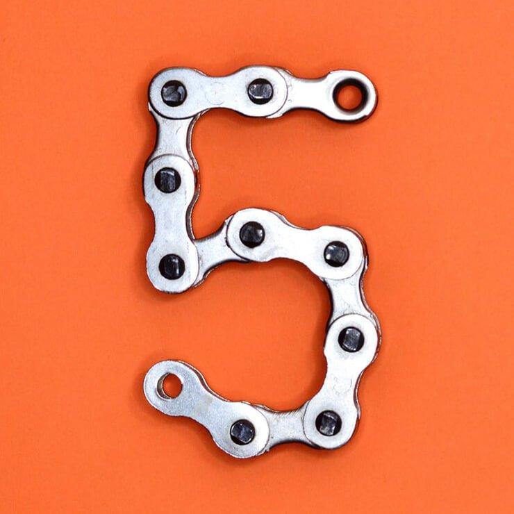 bike chain in the shape of the number 5 on orange background