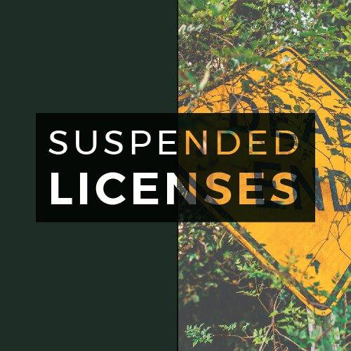 suspended licenses text overlaid on dead end sign and dark green background