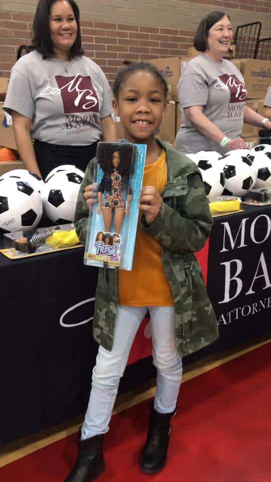 iheart's toy drive and little girl with her new doll