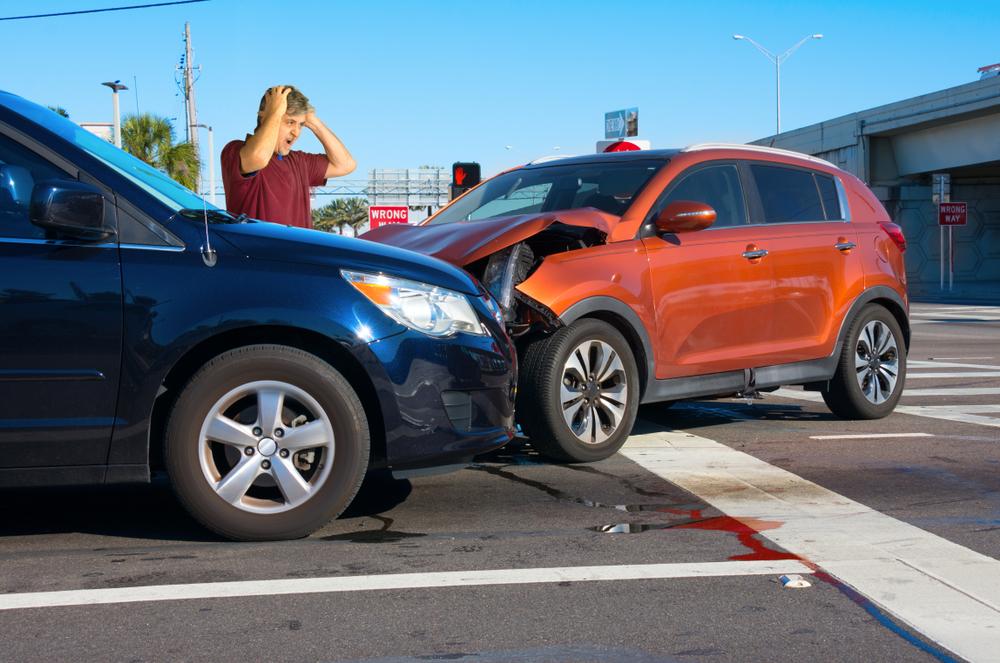 blue and orange car colliding at intersection