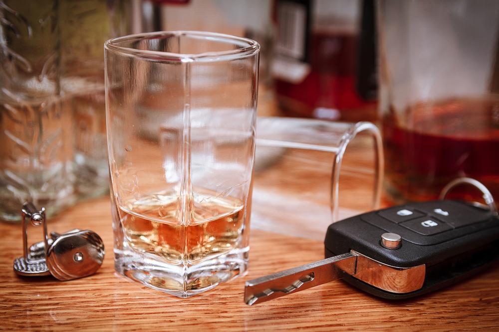 car key on bar with spilled alcohol