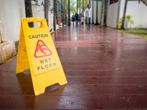 yellow sign warns hotel guests of a wet floor
