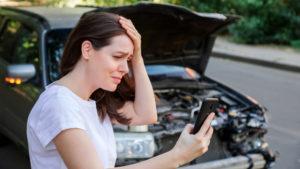 a distressed woman holding her head after a car accident