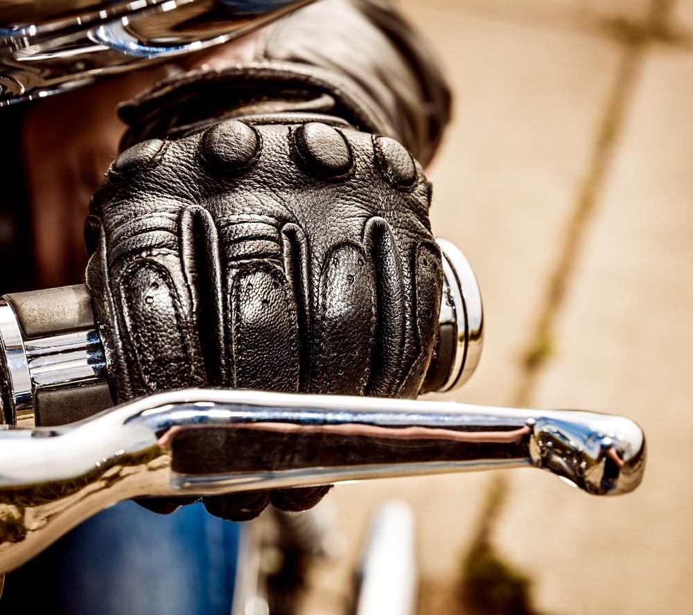 close-up of a motorcyclist’s hand on the handle