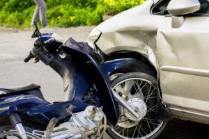close-up of car and motorcycle crash