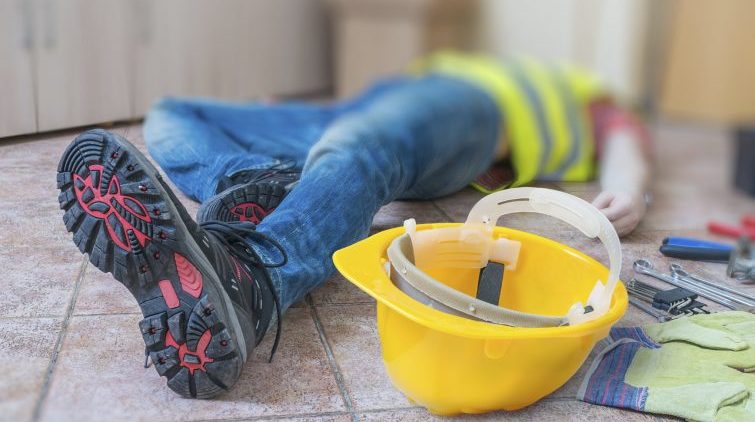 injured construction worker lying on the floor