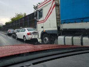 truck accident on highway seen from passing car