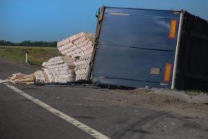 cargo spills out of overturned truck
