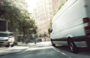 delivery van speeds along city street