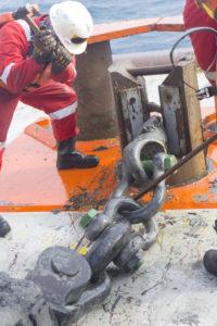 marine crew performs anchor handling setup