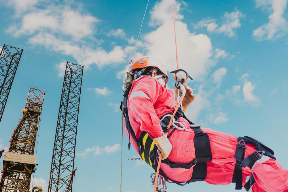 abseiler with protective equipment working on offshore rig