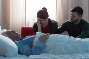 grieving adult children at hospital bedside of deceased parent