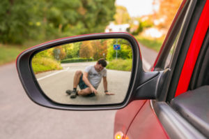 injured pedestrian reflected in vehicle’s side mirror