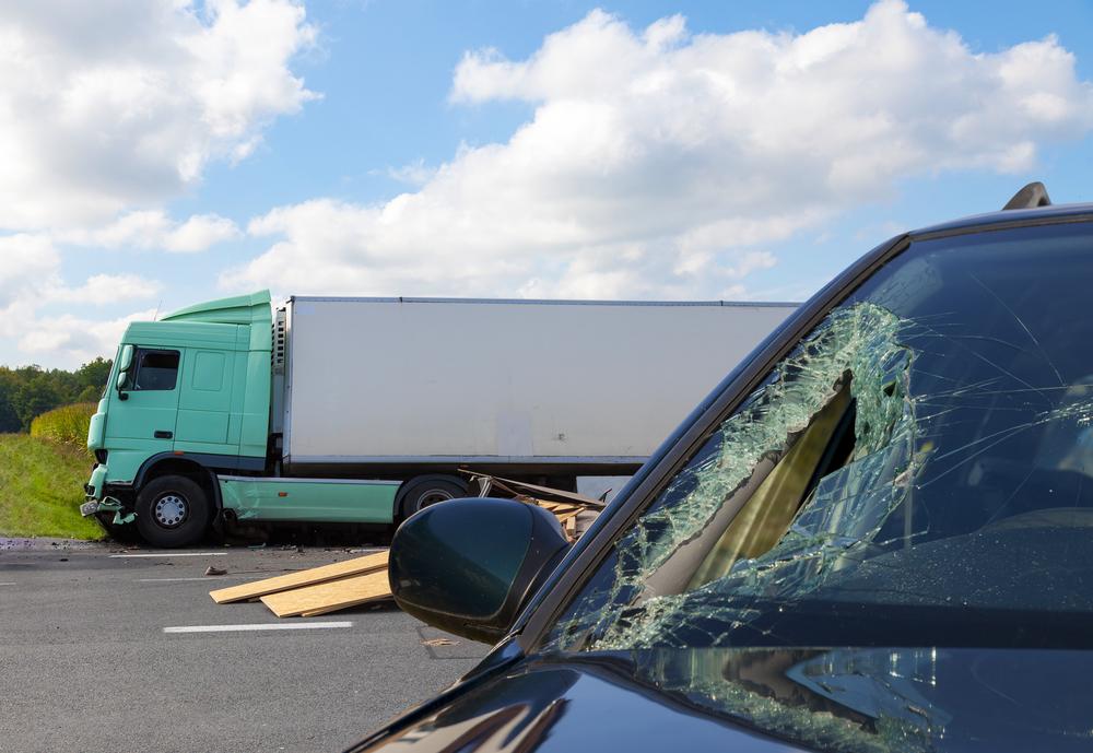 vehicle damage after collision with large truck