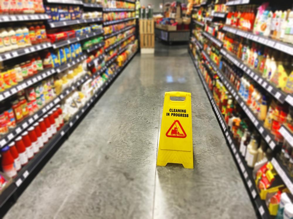 wet floor sign on grocery store aisle