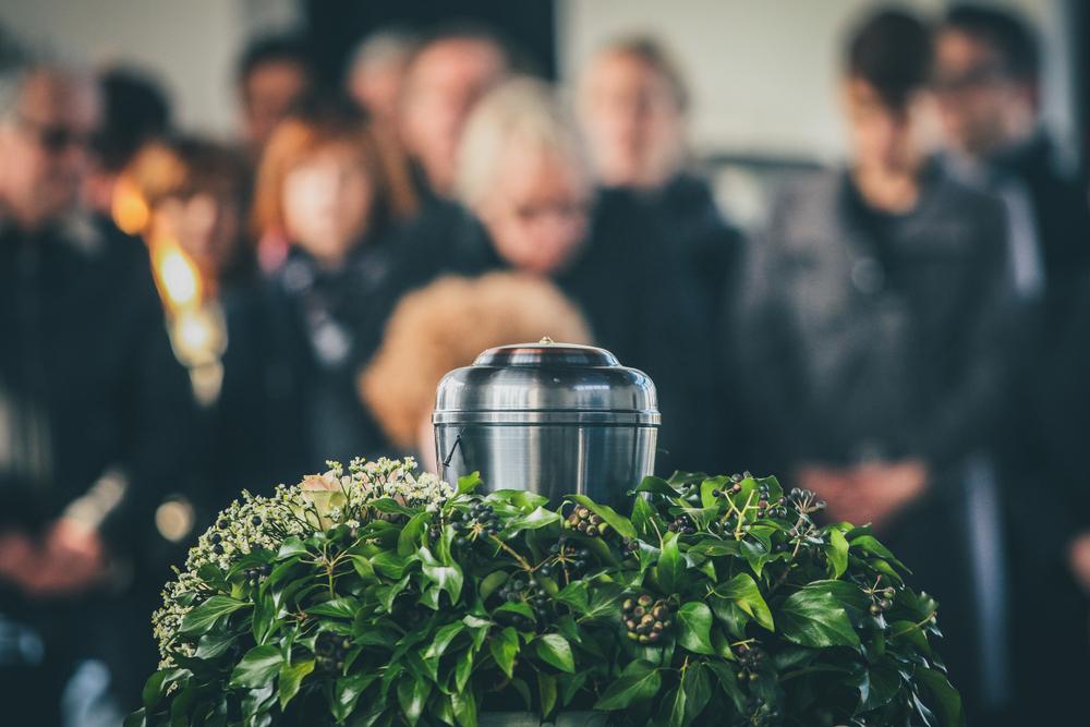 family mourns in front of urn