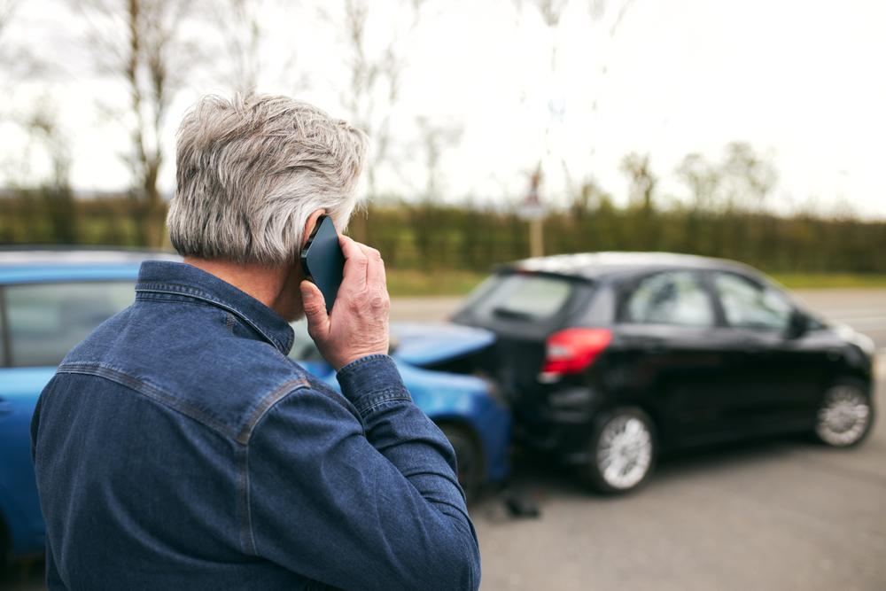 man calls his auto insurer to assess vehicle damage