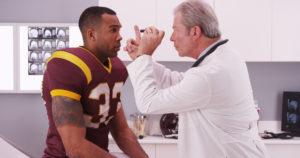 college football player visits doctor after game injury