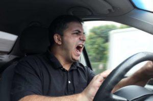 motorist shouting in anger behind the wheel