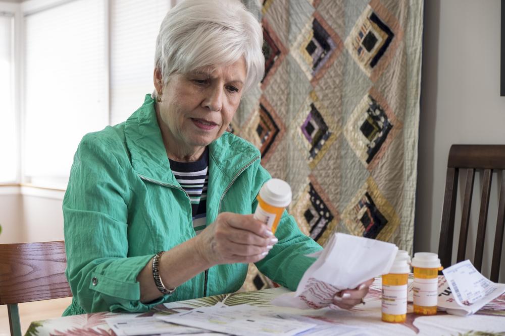 woman carefully reads medication instructions