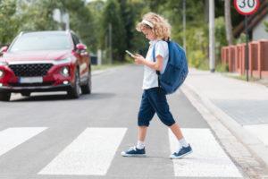 child crosses the street
