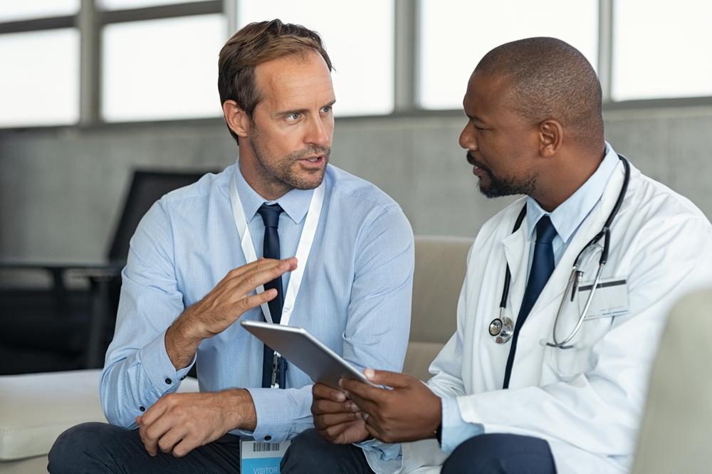 businessman talking to a doctor