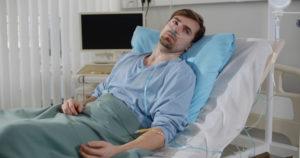 man lying in a hospital bed