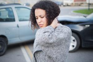 woman holding neck after a car accident