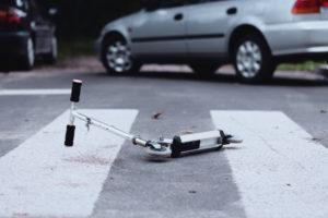 scooter lying in a crosswalk after an accident