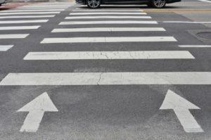 pedestrian crossing arrows on asphalt
