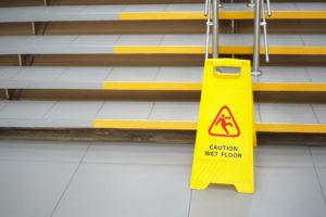 wet floor sign by stairs