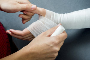 doctor bandaging a woman’s hand